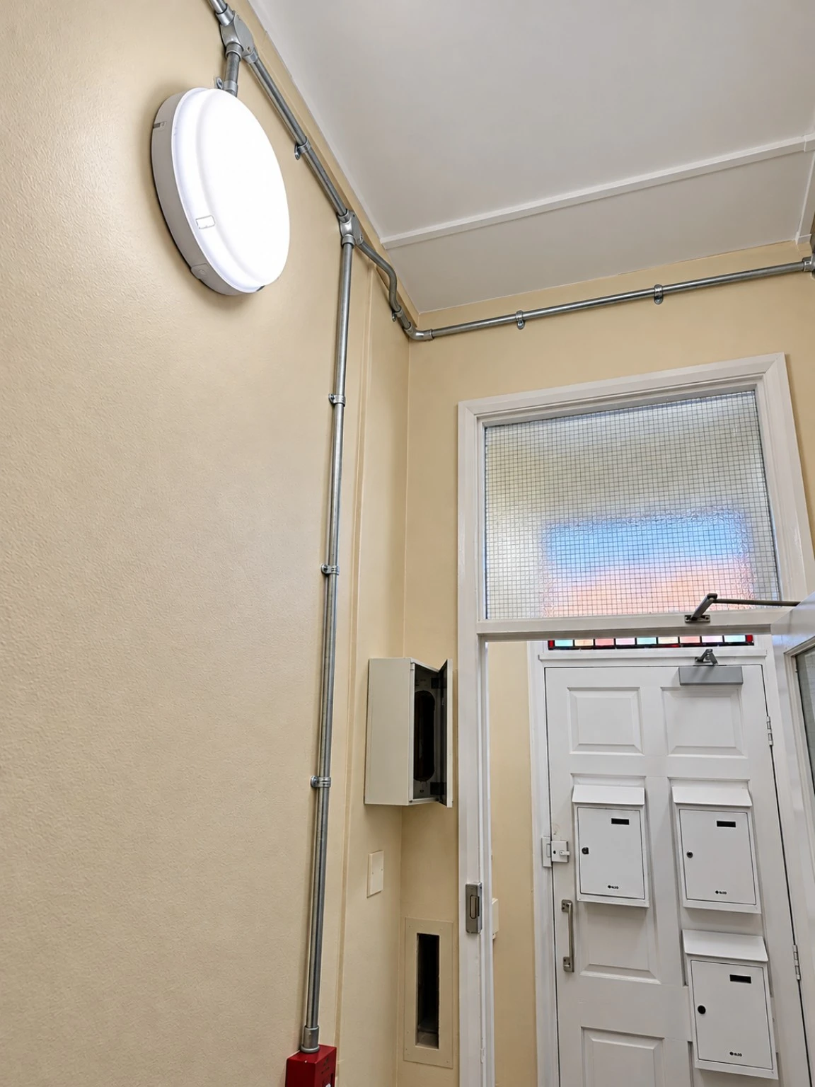 Communal entrance lighting and electrical conduit